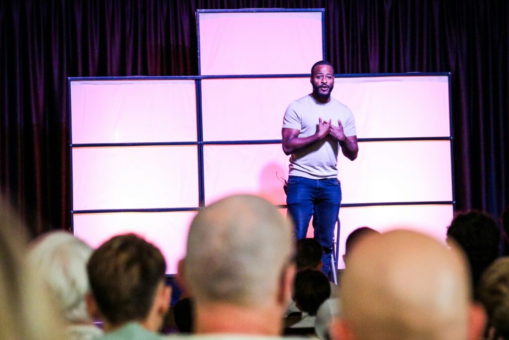 A man speaking to a large audience