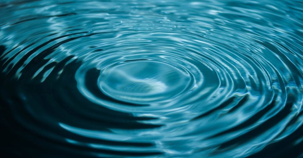 A pool of water with concentric ripples spreading out from a single drop