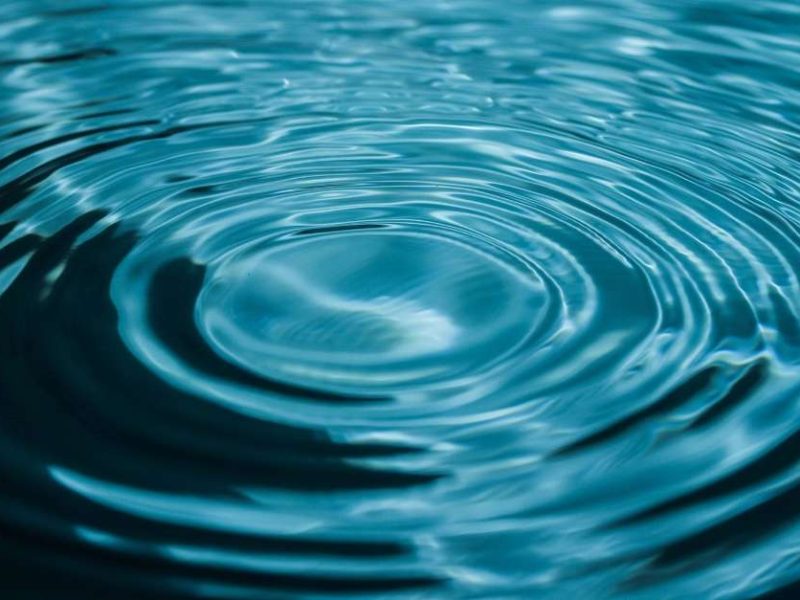 A pool of water with concentric ripples spreading out from a single drop