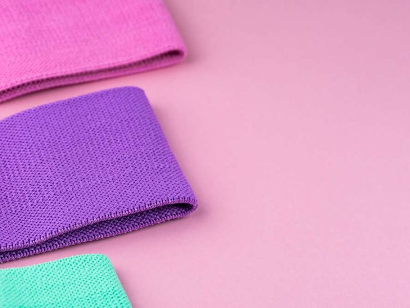 3 resistance bands used in the gym, lying on a flat surface