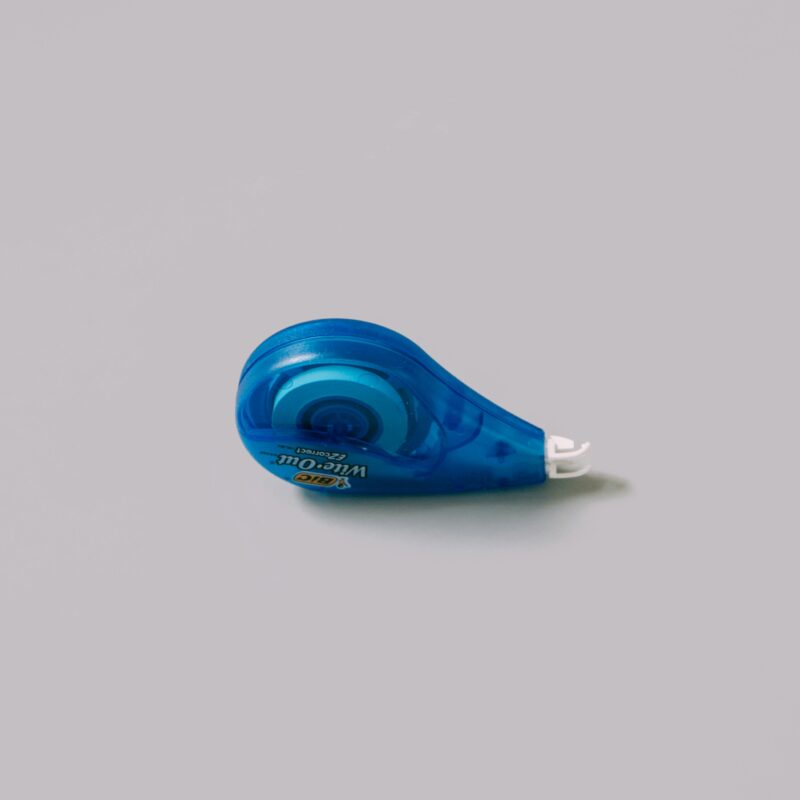 A blue wite out tape dispenser