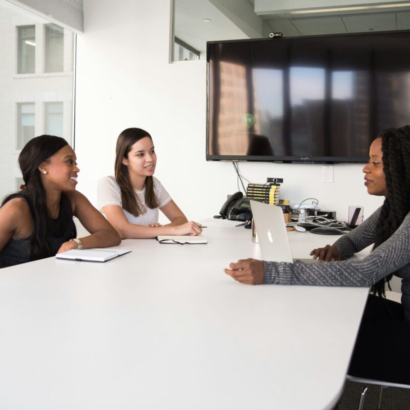 Two women interviewing another woman for a job interview