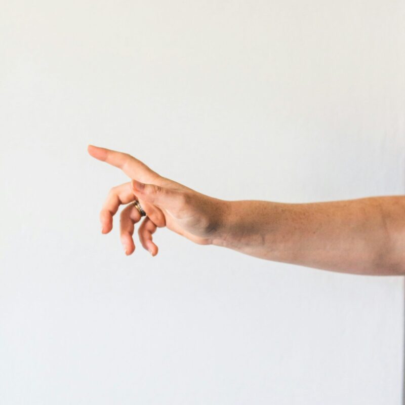 Hand gesture with the index finger pointing up